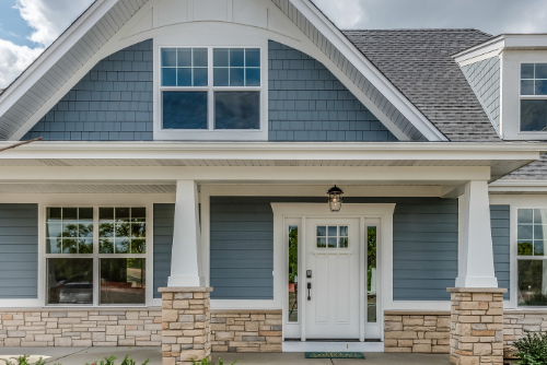Stylish house exterior with blue siding, white trim, and a gray roof.